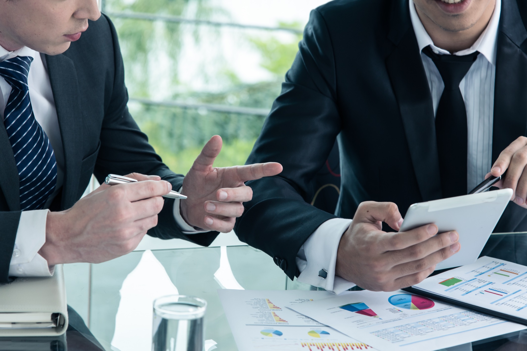 Two businessman using tablet